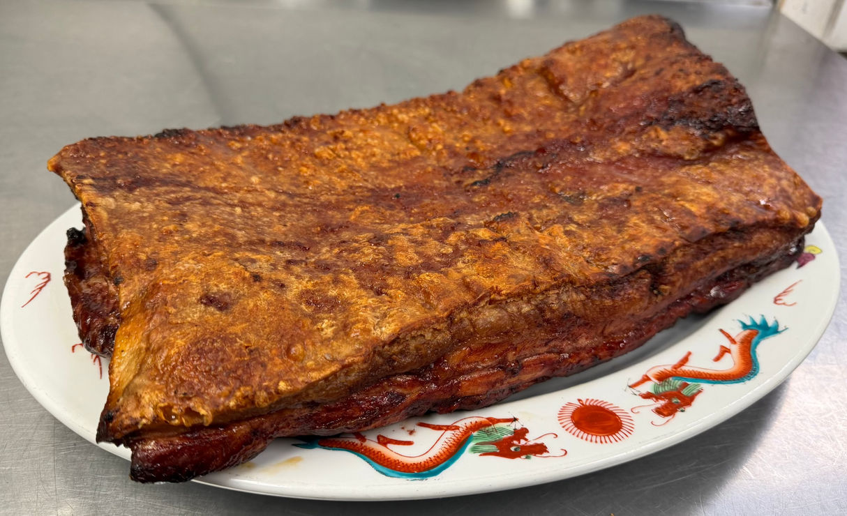 Cantonese Roast Pork Belly slab on a decorative plate.