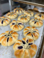 Baked pastries with sweet ube filling on a baking tray